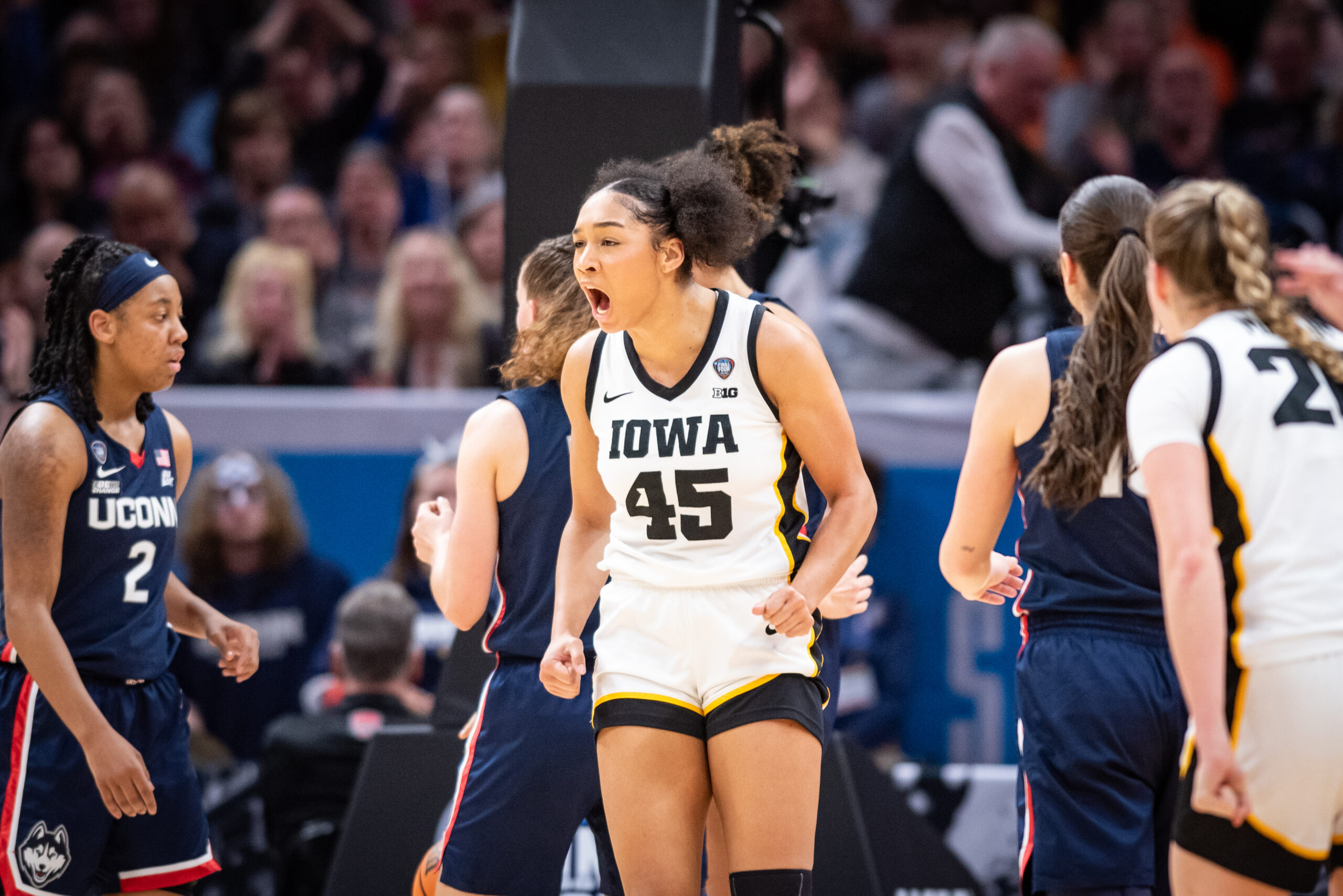 Iowa forward Hannah Stuelke yells and clenches her fists in celebration.