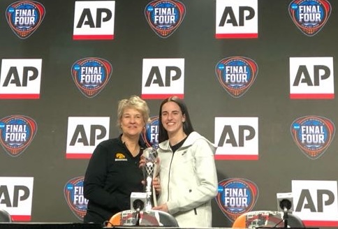 Iowa's Lisa Bluder and Caitlin Clark smile for a photo with Clark's AP Player of the Year trophy.