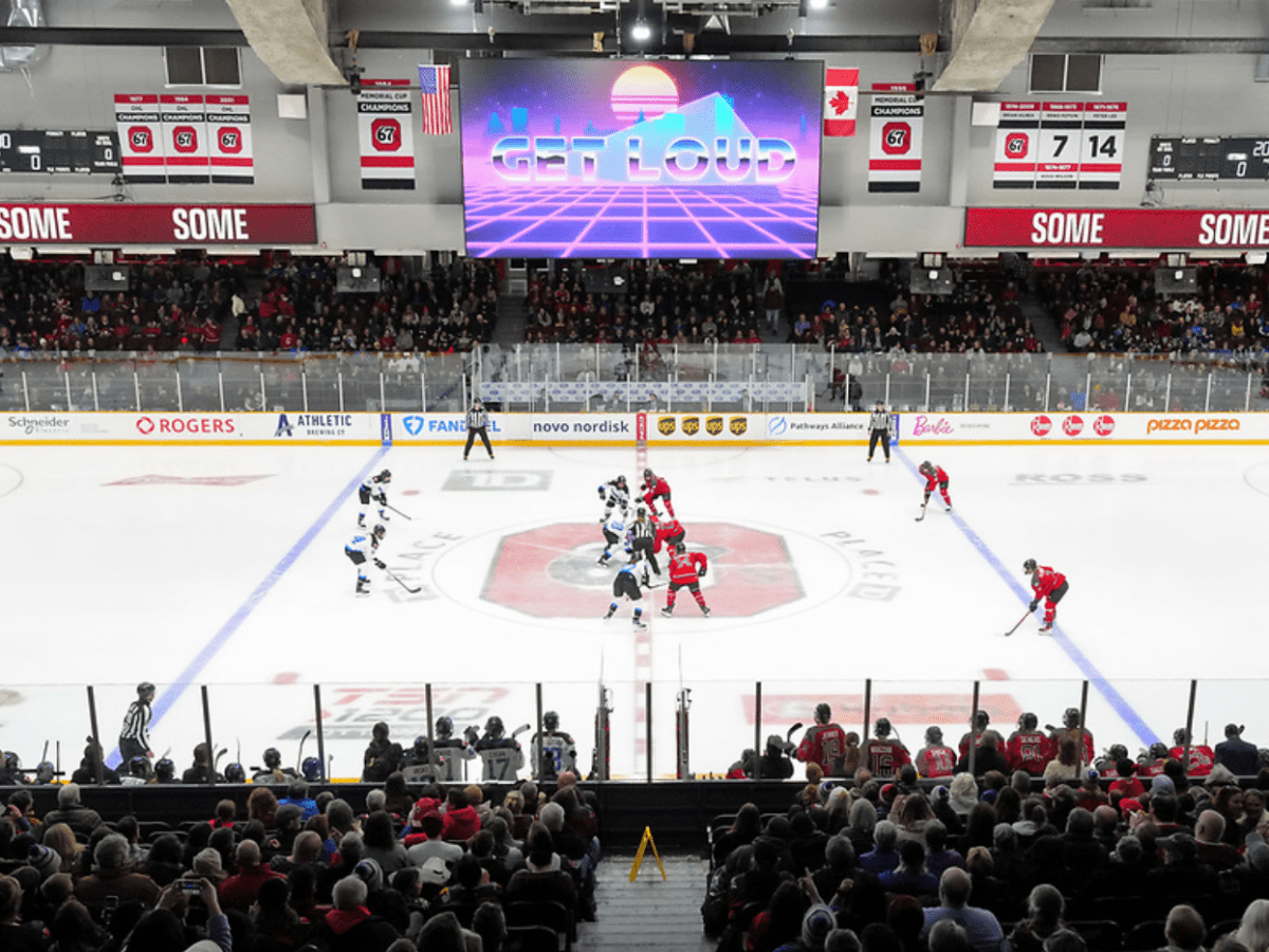 A distance shot of Ottawa and Toronto lined up for a faceoff. Ottawa is in red, Toronto is in white.