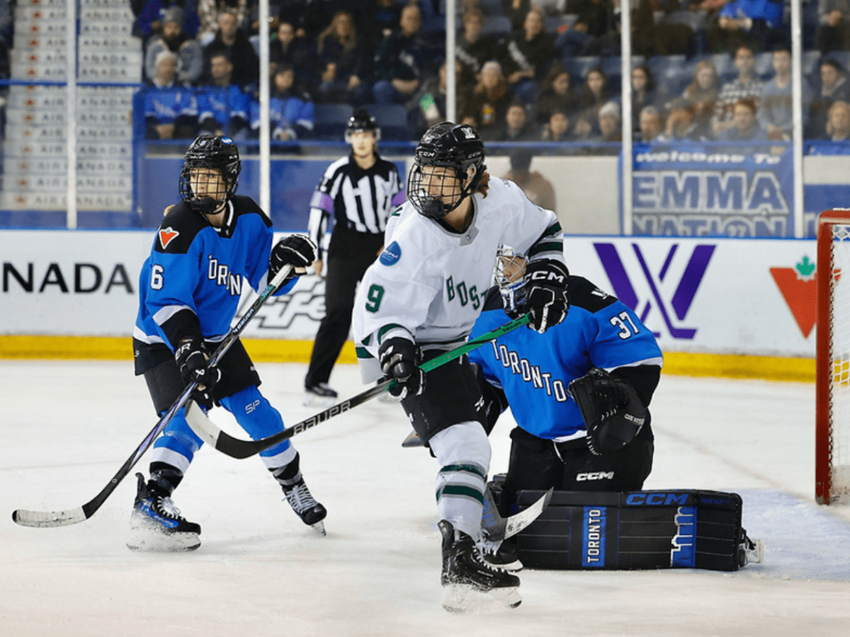 Shirley (right) and Flanagan (left) turn their heads to watch the play behind them while in front of Campbell's crease.