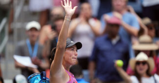 Garbine Muguruza waves to the crowd following a match