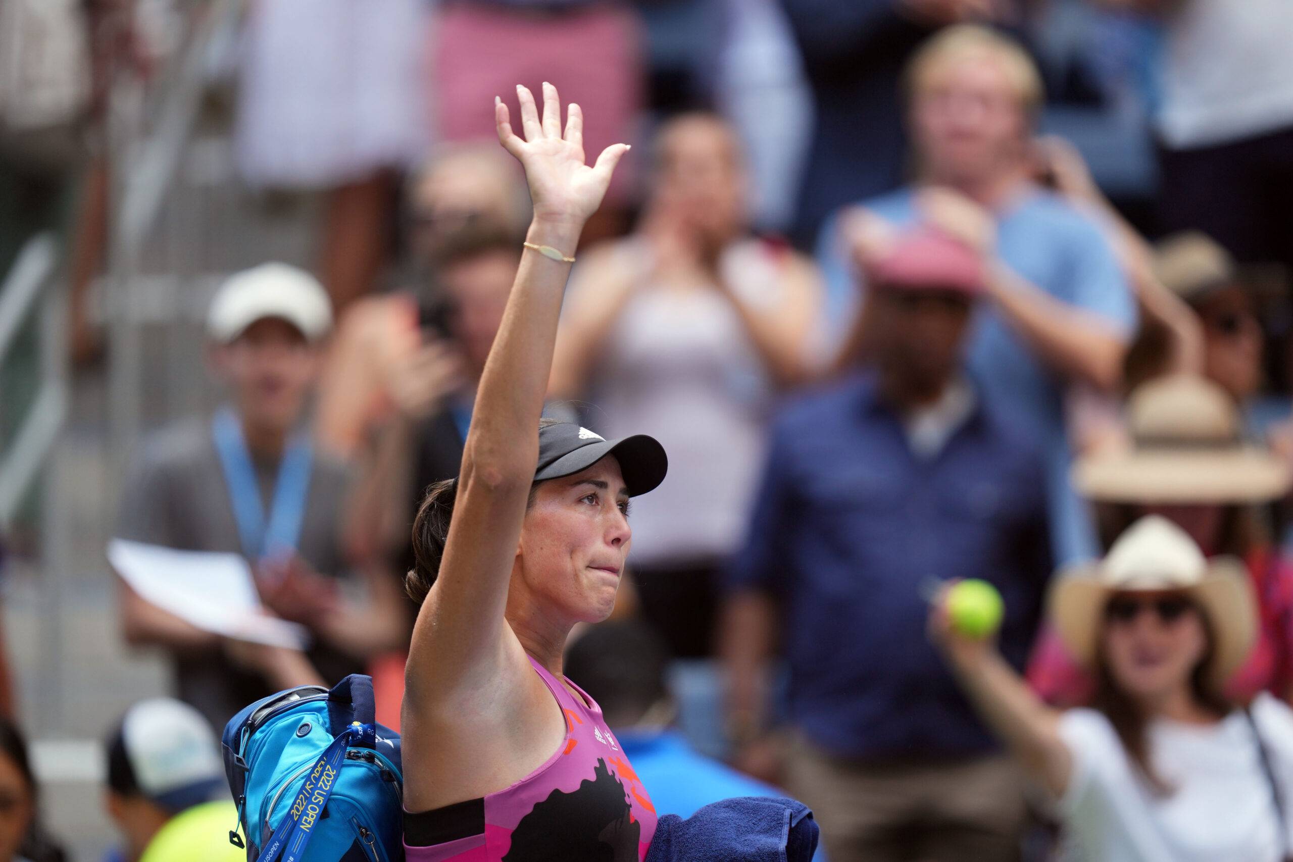 Garbine Muguruza waves to the crowd following a match