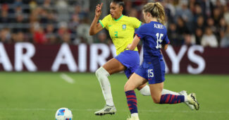 Korbin Albert battles with Brazil defender Tarciane