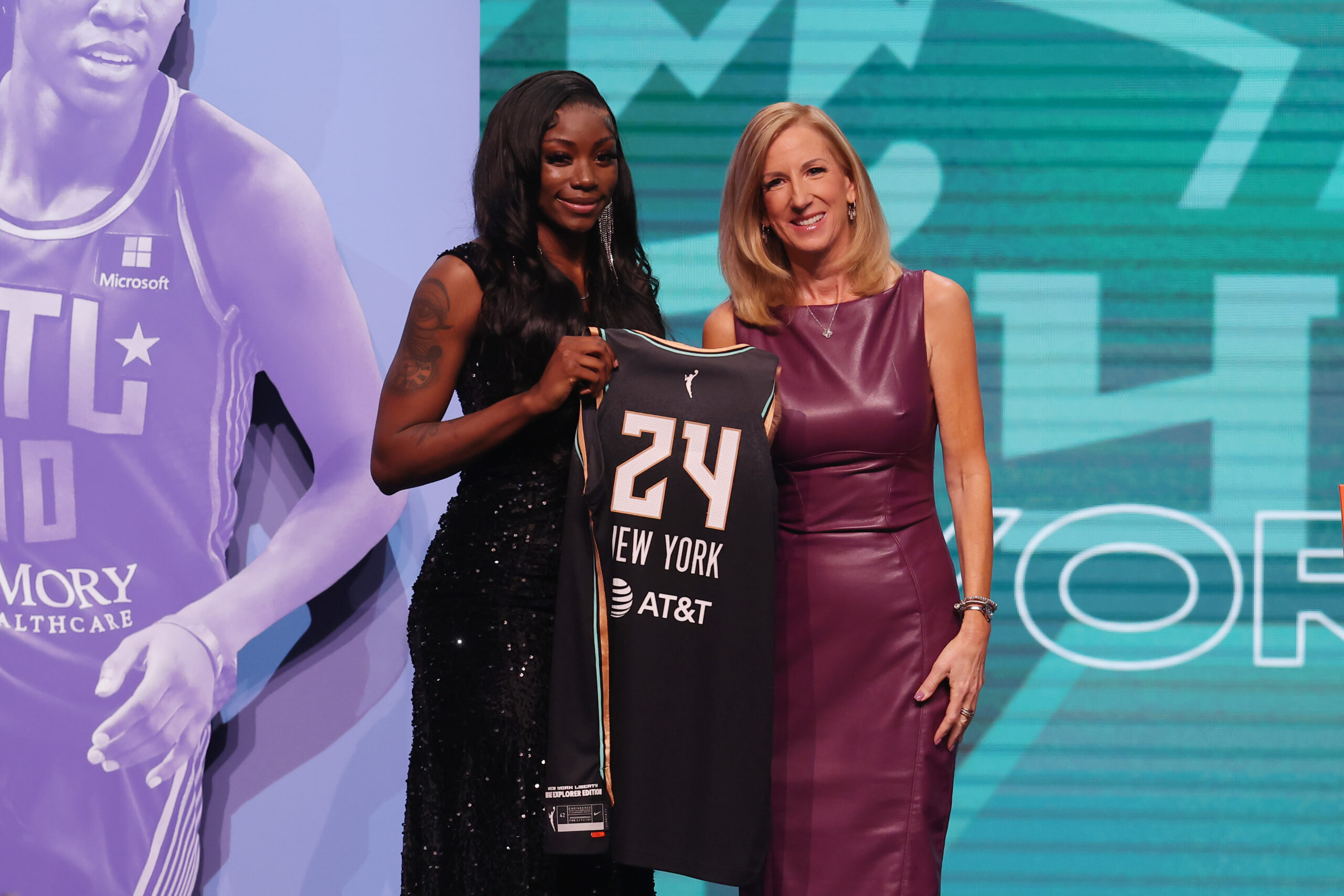 11th overall pick Marquesha Davis stands with WNBA Commissioner Cathy Engelbert after getting drafted by the New York Liberty.