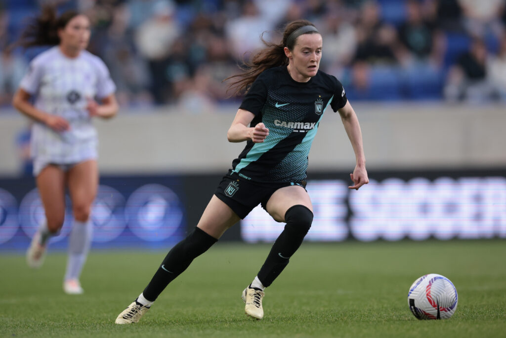 Rose Lavelle handles the soccer ball wearing a black Gotham uniform