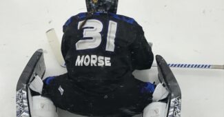 Goalie Allie Morse is pictured stretching on the ice