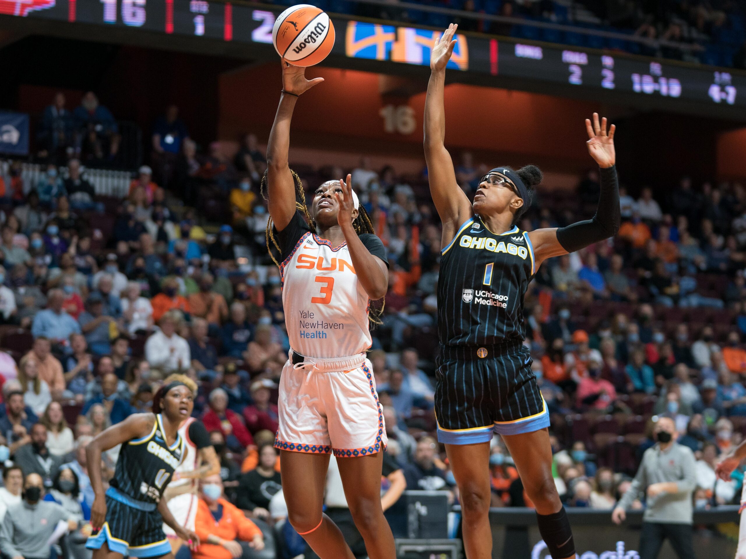 Sky guard Diamond DeShields goes up for the block with her right hand while Connecticut guard Kaila Charles goes up for a layup