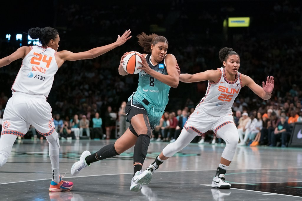 Nyara Sabally drives to the rim.