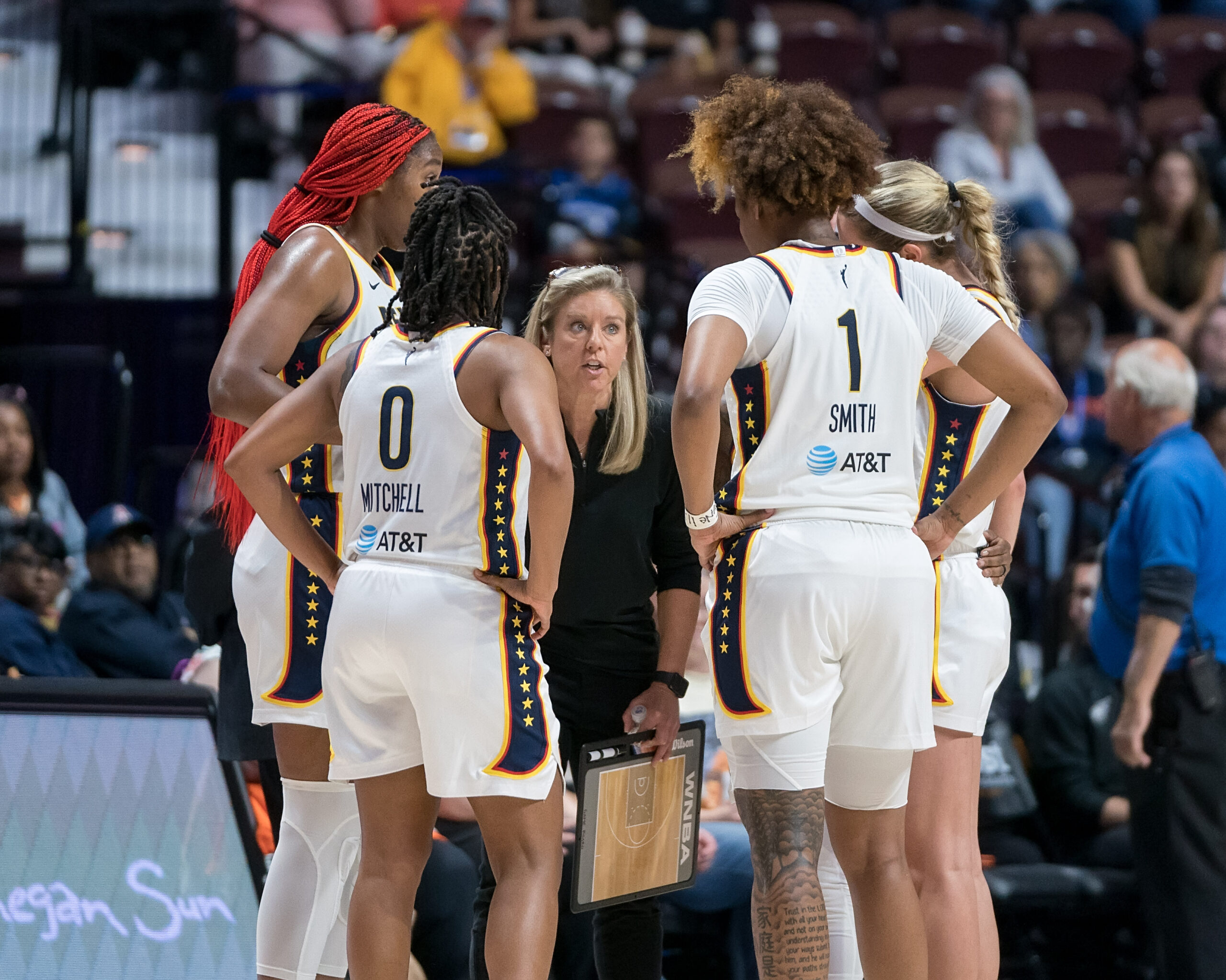 Indiana Fever head coach Christie Sides talks to huddled up Indiana Fever players during a timeout