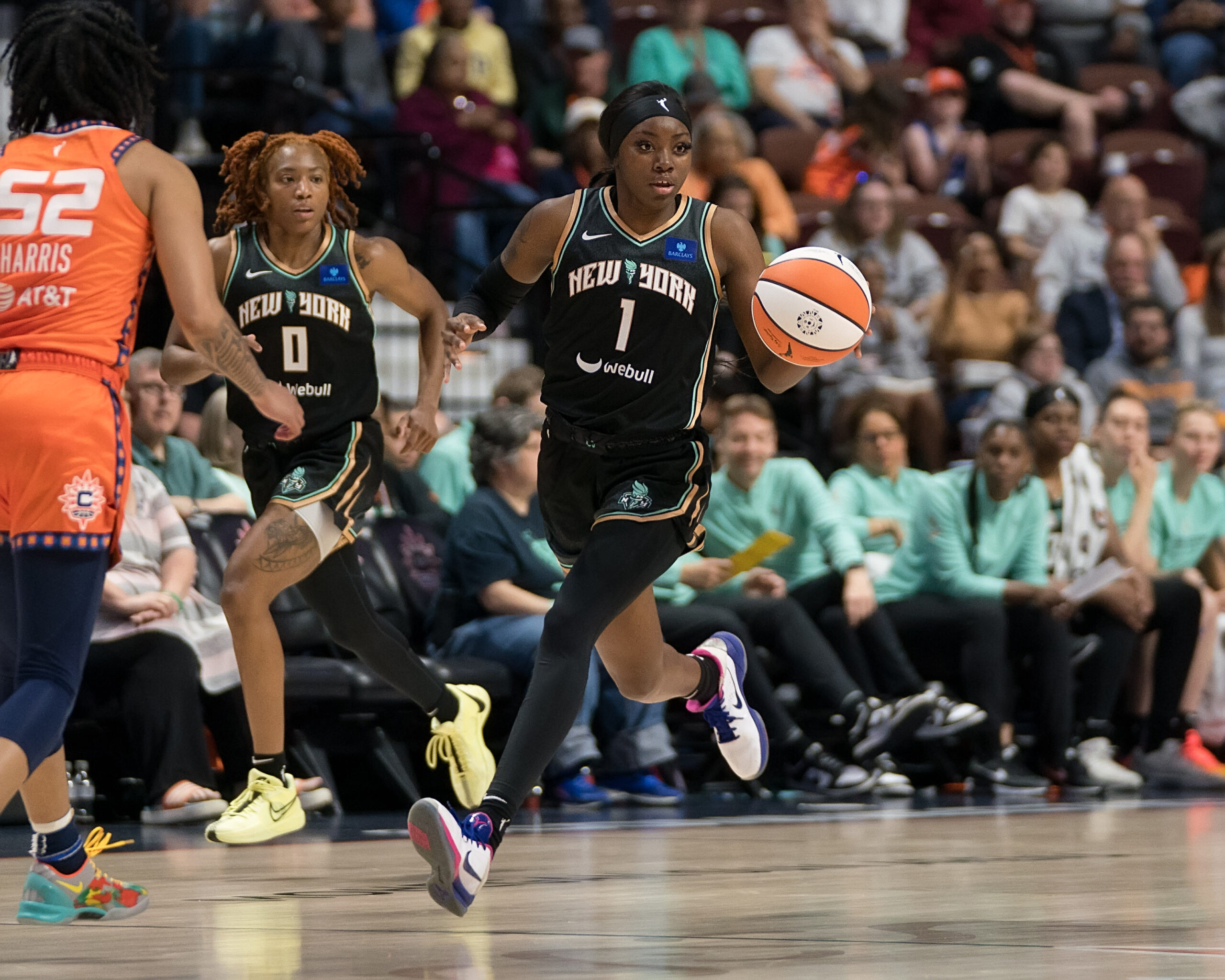 Marquesha Davis handles the ball with Jaylyn Sherrod training behind her.