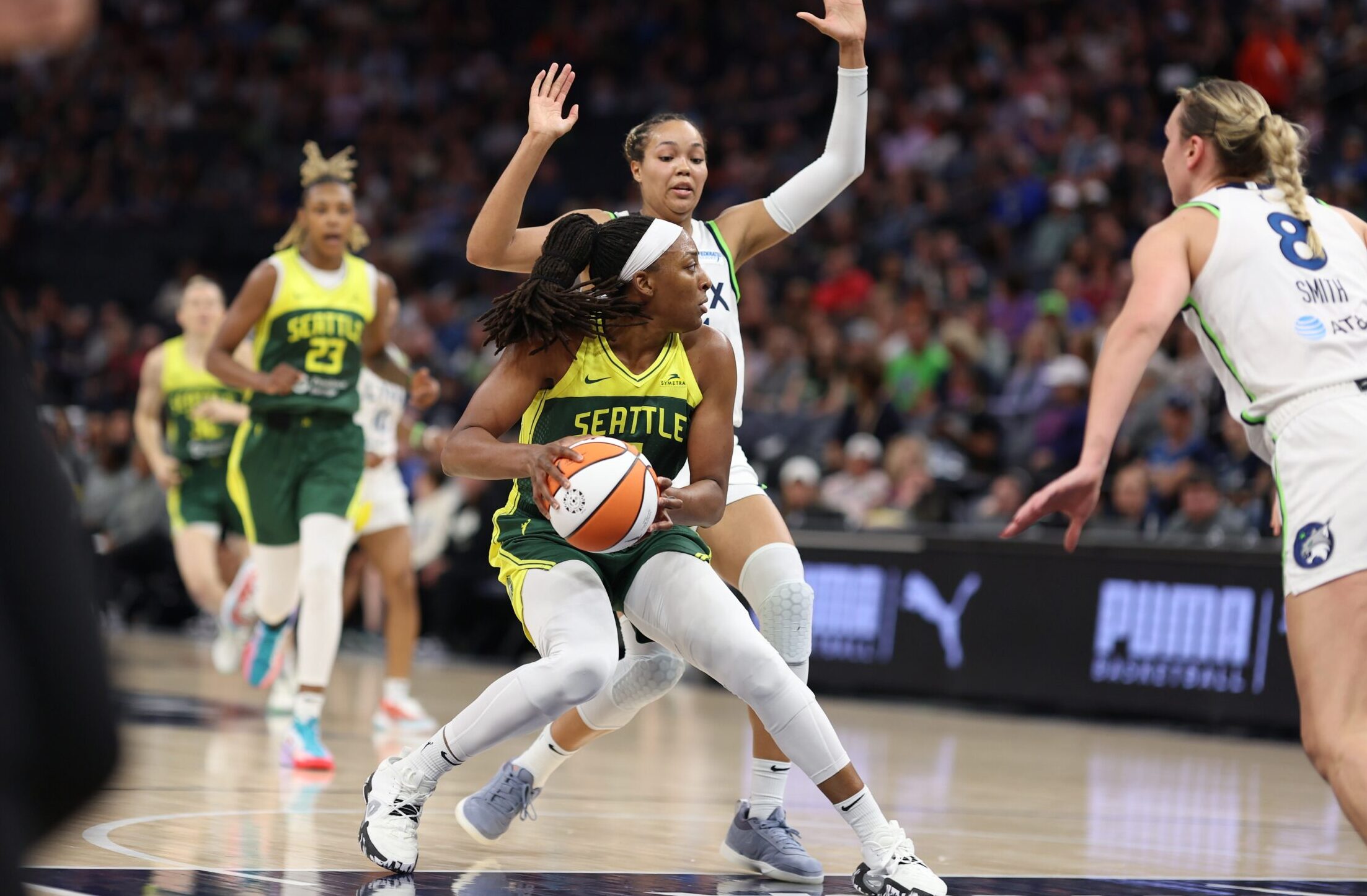 Seattle Storm forward Nneka Ogwumike holds the ball at her waist while Minnesota Lynx forward Napheesa Collier defends on her back.