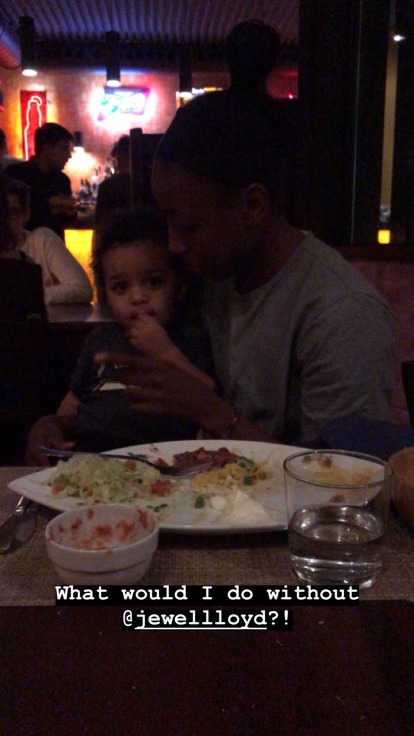 Justin Swan sits on Jewell Loyd’s lap at a restaurant in Italy