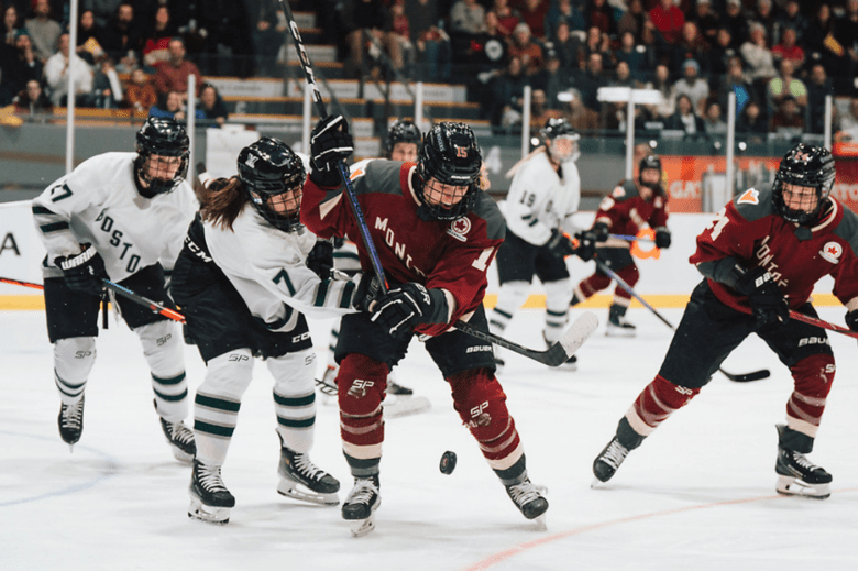 Boston and Montréal players battle over the puck in front of the crease. Montréal is currently in possession.