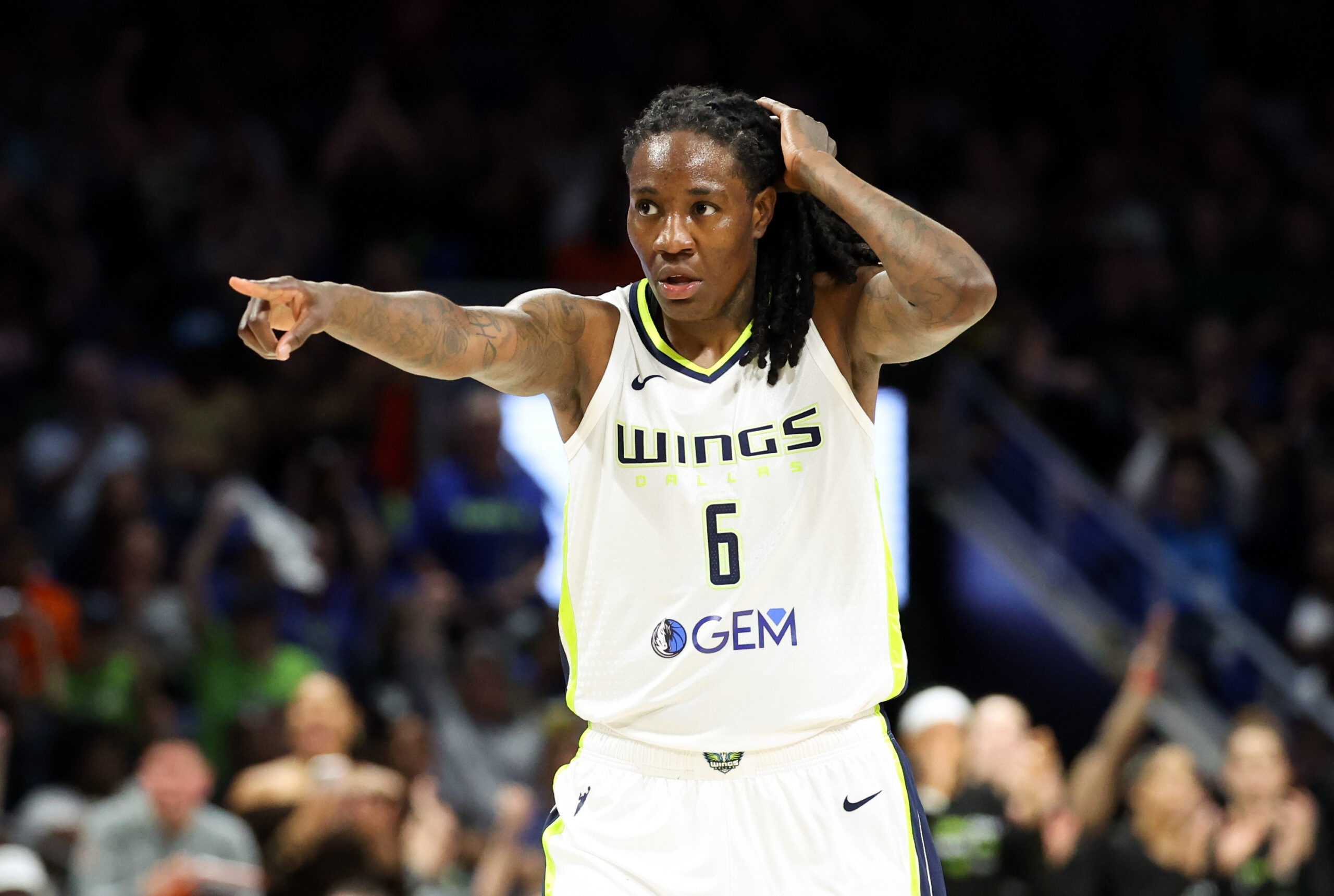 Wings forward directs traffic while on the basketball court