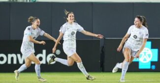 Savannah DeMelo runs to celebrates with teammates after tying a game
