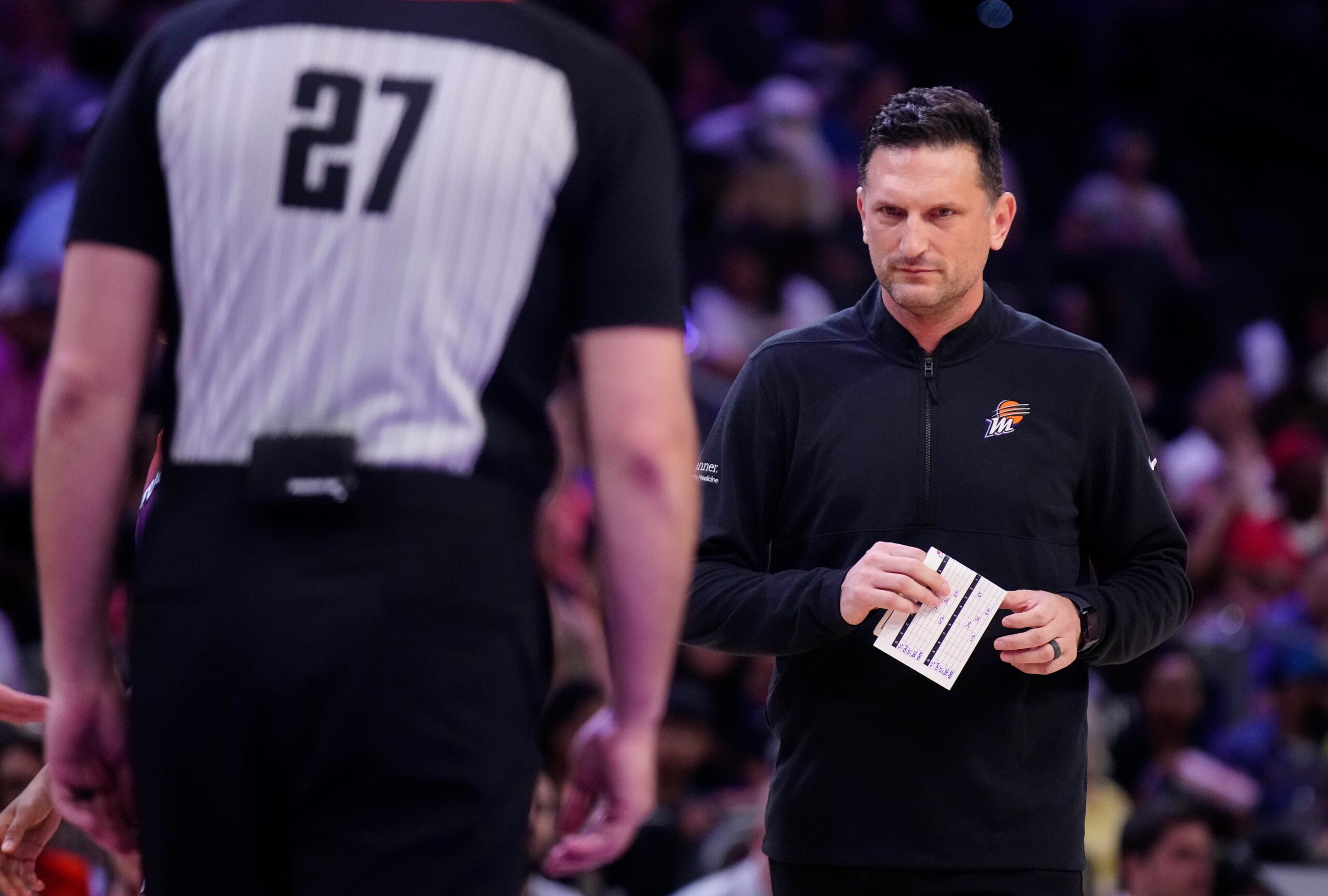 Mercury head coach Nate Tibbetts watches his team with a paper in his hand