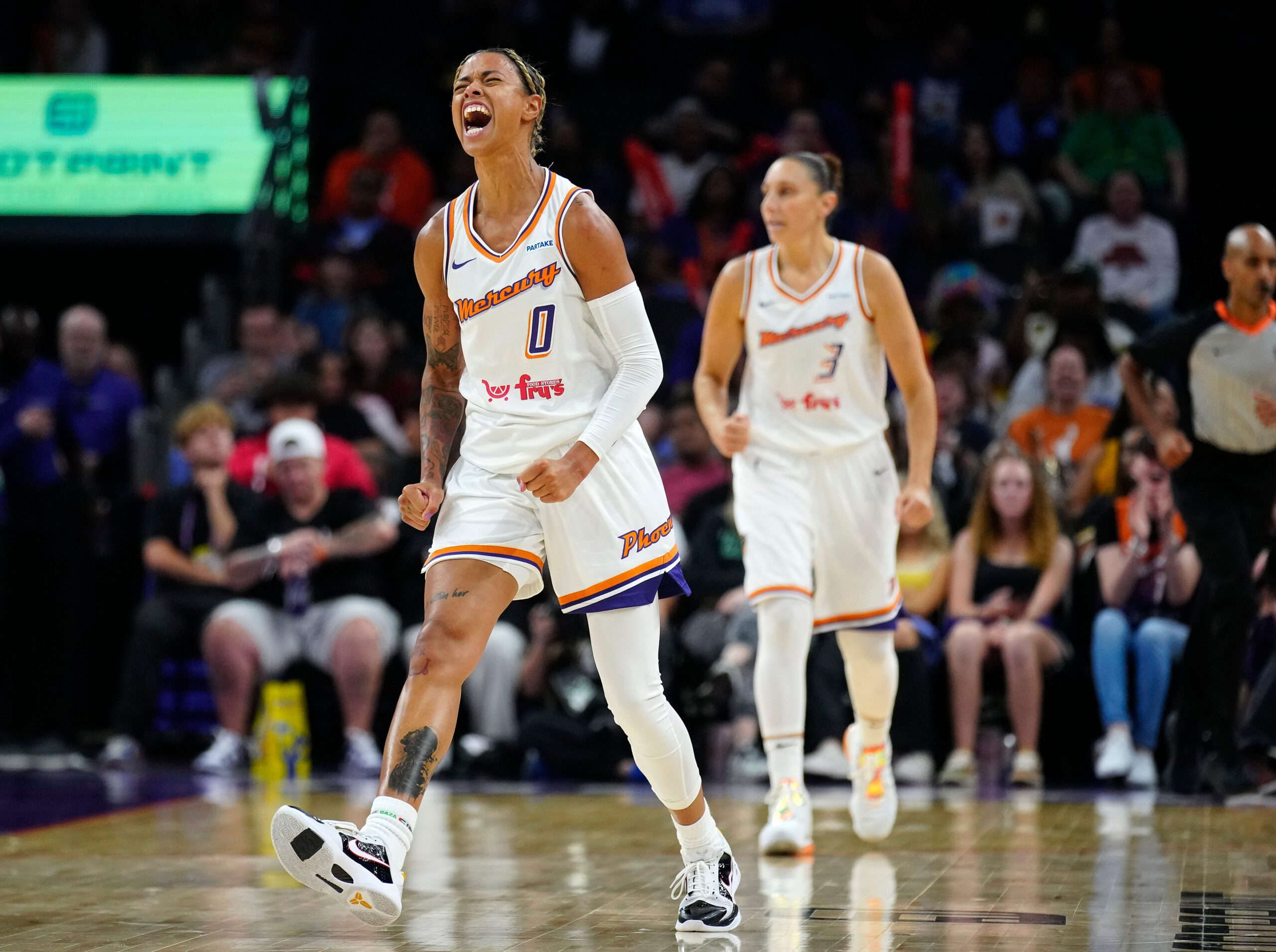 Mercury guard Natasha Cloud (0) yells in celebration against the Mystics