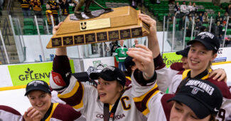 Concordia University teammates celebrate U SPORTS championship by hoisting trophy