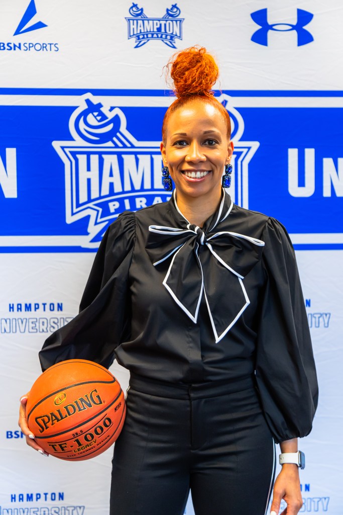 Portrait of Tamisha Augustin smiling and holding a basketball