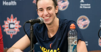 Caitlin Clark talks to the media.