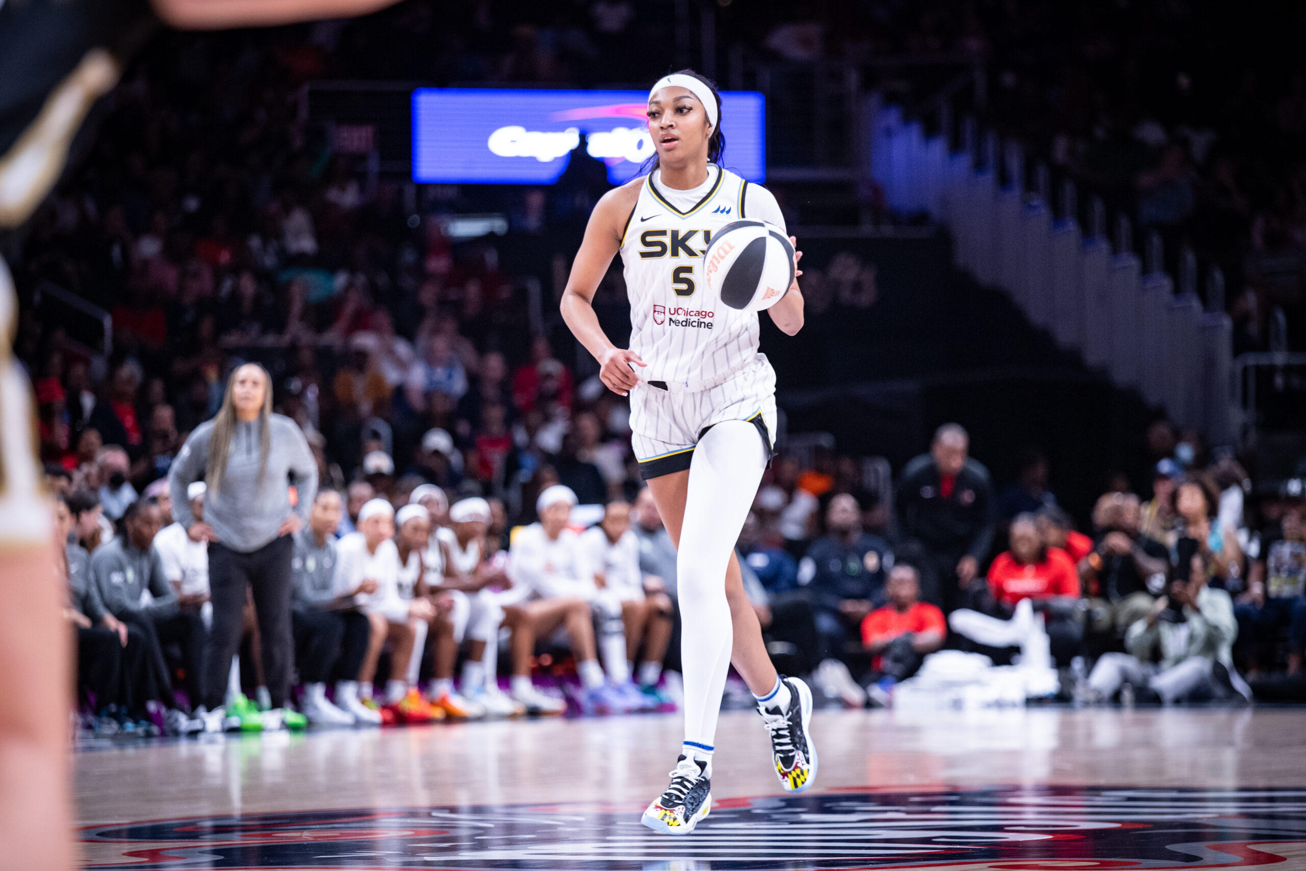 Chicago Sky forward Angel Reese dribbles the ball with her left hand, facing no defensive pressure.