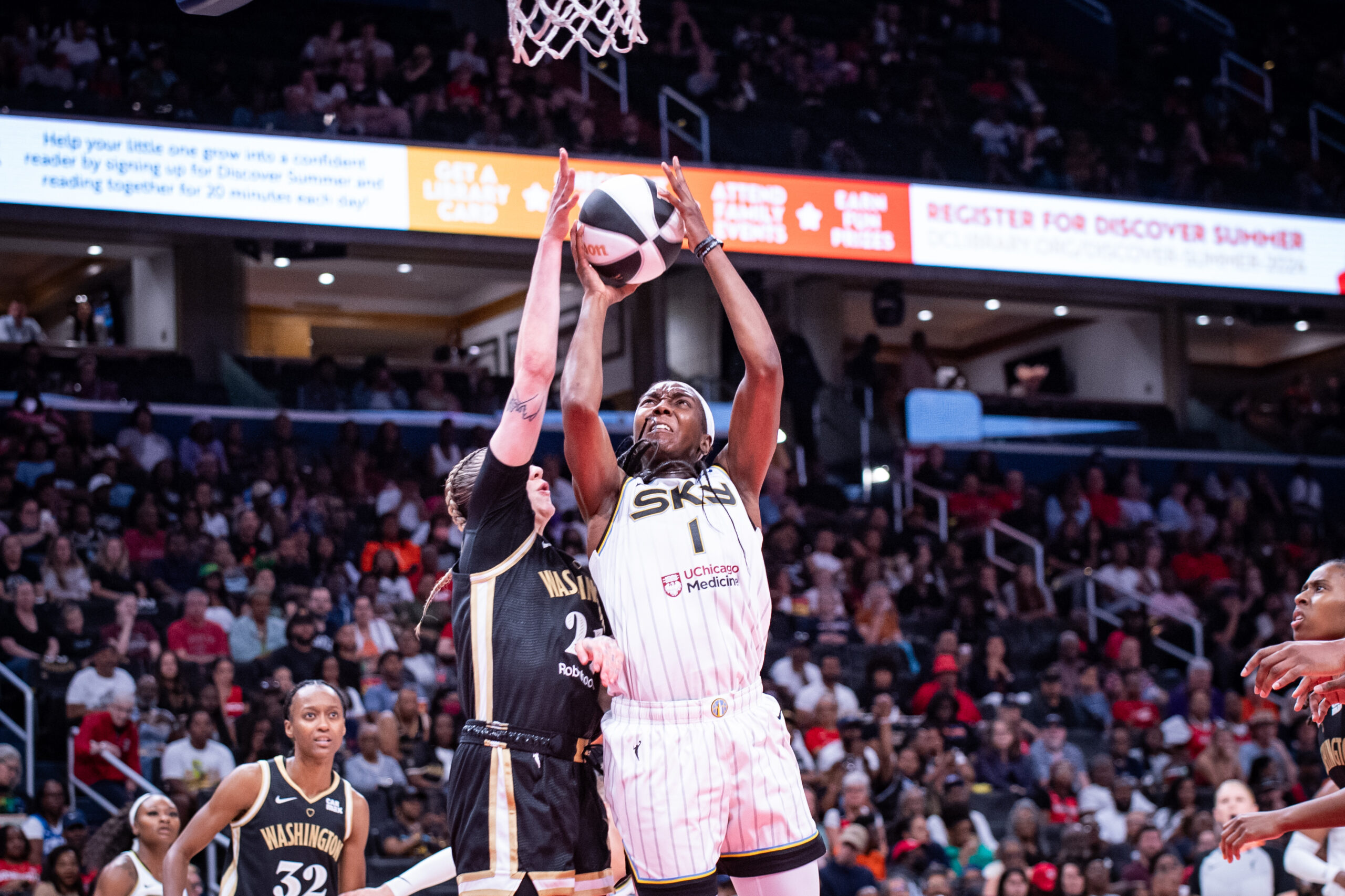 Sky center Elizabeth Williams extends toward the hoop with both hands to shoot the ball