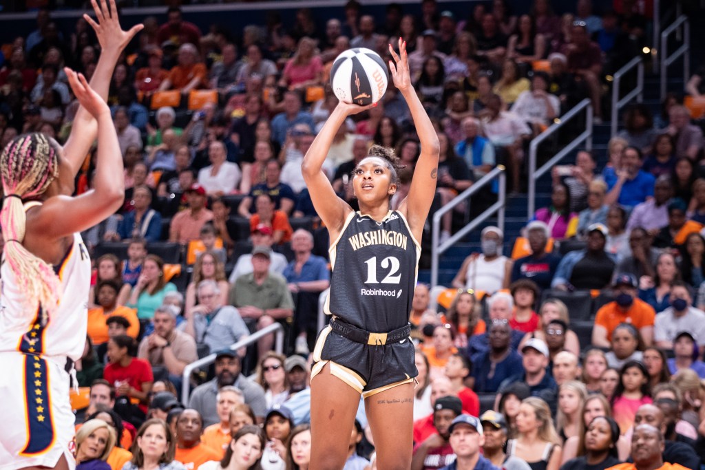 Washington Mystics guard DiDi Richards attempts a right-handed jump shot as an Indiana defender is too late to contest it.