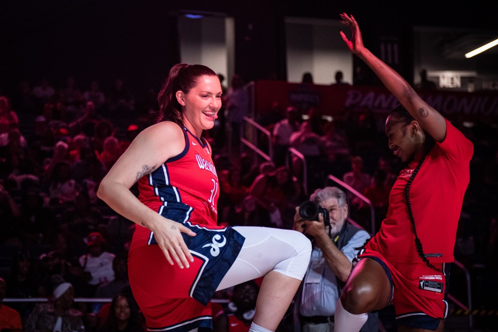 Washington Mystics wing DiDi Richards and center Stefanie Dolson face each other, stick out their tongues, stick their right hips out and slap their butts.
