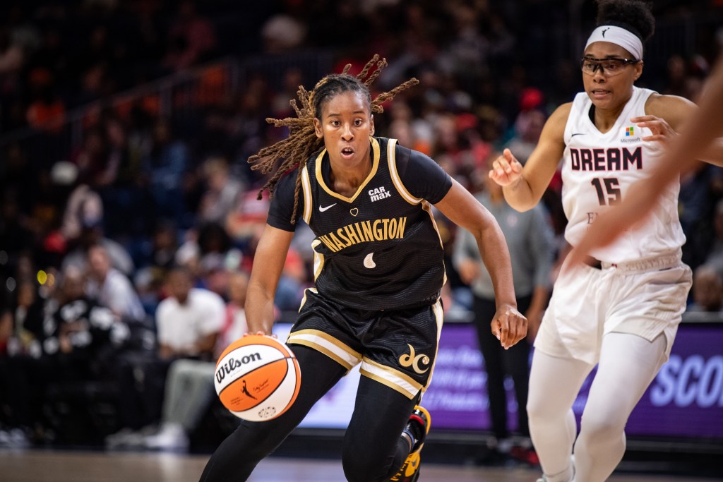 Washington Mystics guard Ariel Atkins dribbles past Atlanta Dream guard Allisha Gray with her right hand.