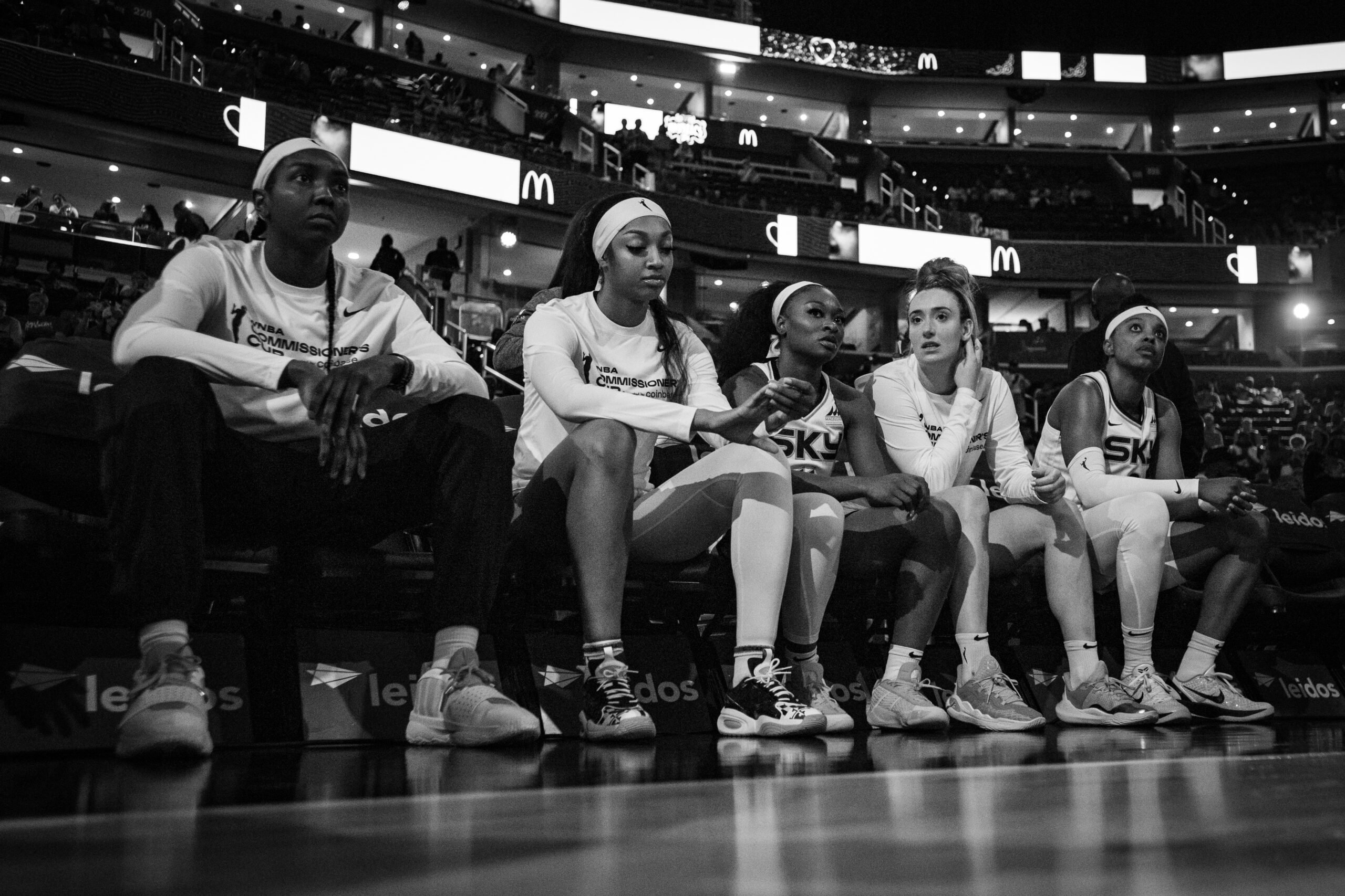 Chicago Sky players Elizabeth Williams, Angel Reese, Dana Evans and Marina Mabrey sit on the bench before the game starts