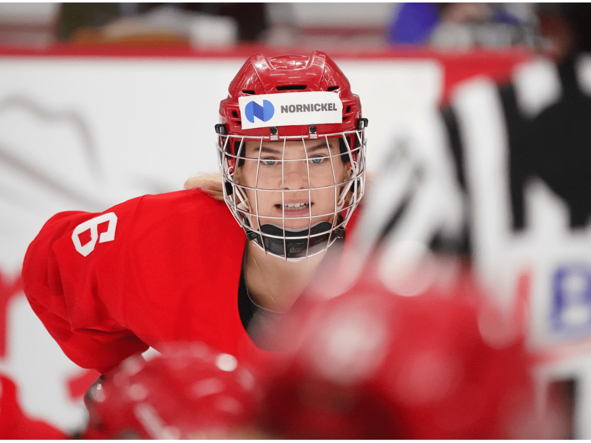 Ilona Markova in a red Russian Olympic Committee jersey lines up for a face off.