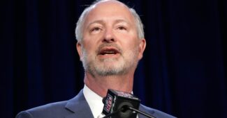 Steve Hill speaks into a microphone.