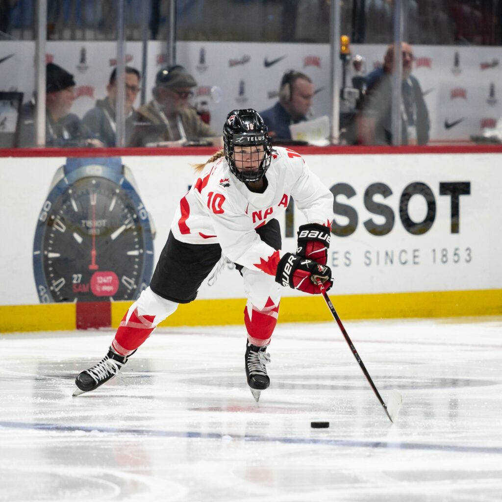 Hockey player Sarah Fillier handles the puck on the ice