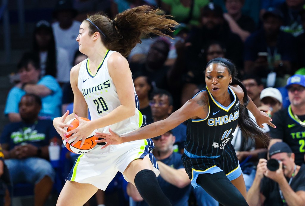 Chicago Sky guard Dana Evans reaches in for a steal on Dallas Wings forward Maddy Siegrist