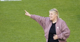 USWNT head coach calls out directions from the sideline