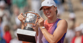 Iga Swiatek smiles with her trophy after winning Roland Garros