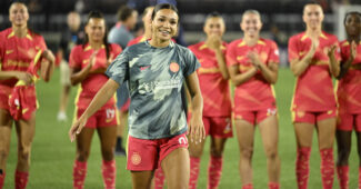 Sophia Smith is pictured smiling on the soccer field in her Portland jersey