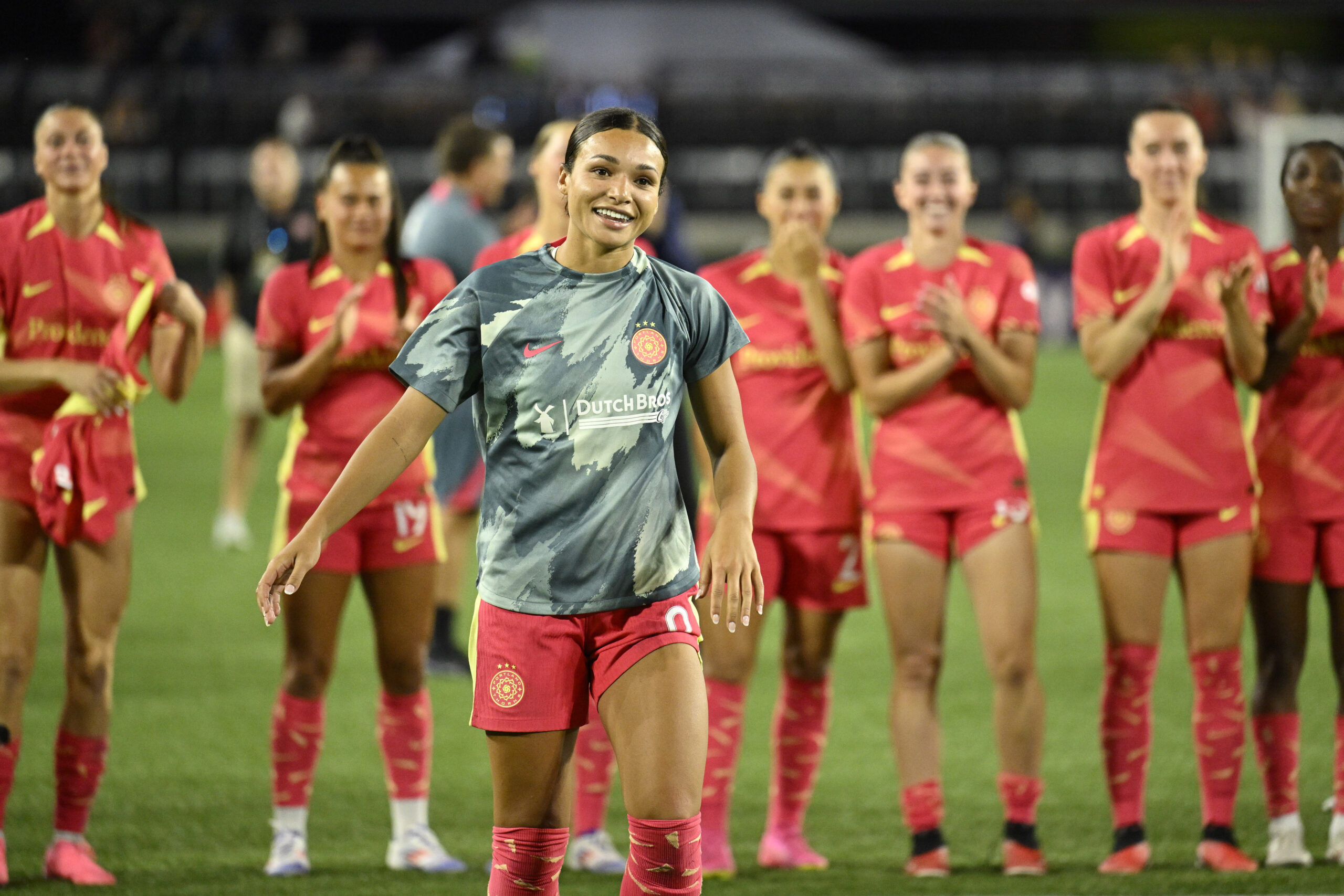 Sophia Smith is pictured smiling on the soccer field in her Portland jersey