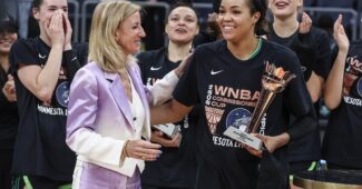 The Minnesota Lynx celebrate with Commissioner Cathy Engelbert.