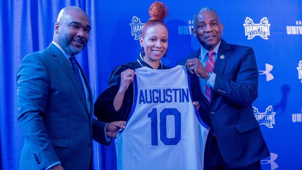Tamisha Augustin holds up a Hampton jersey and is flanked by Anthony Henderson and Darrell K. Williams