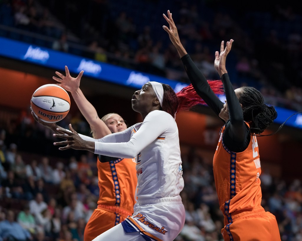 Phoenix Mercury guard-forward Kahleah Copper (2) shoots a layup between two defenders during a WNBA game between the Phoenix Mercury and the Connecticut Sun