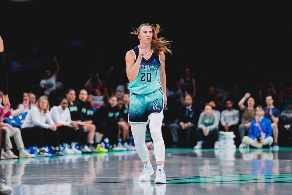 New York Liberty guard Sabrina Ionescu points up with her right index finger after making a play.