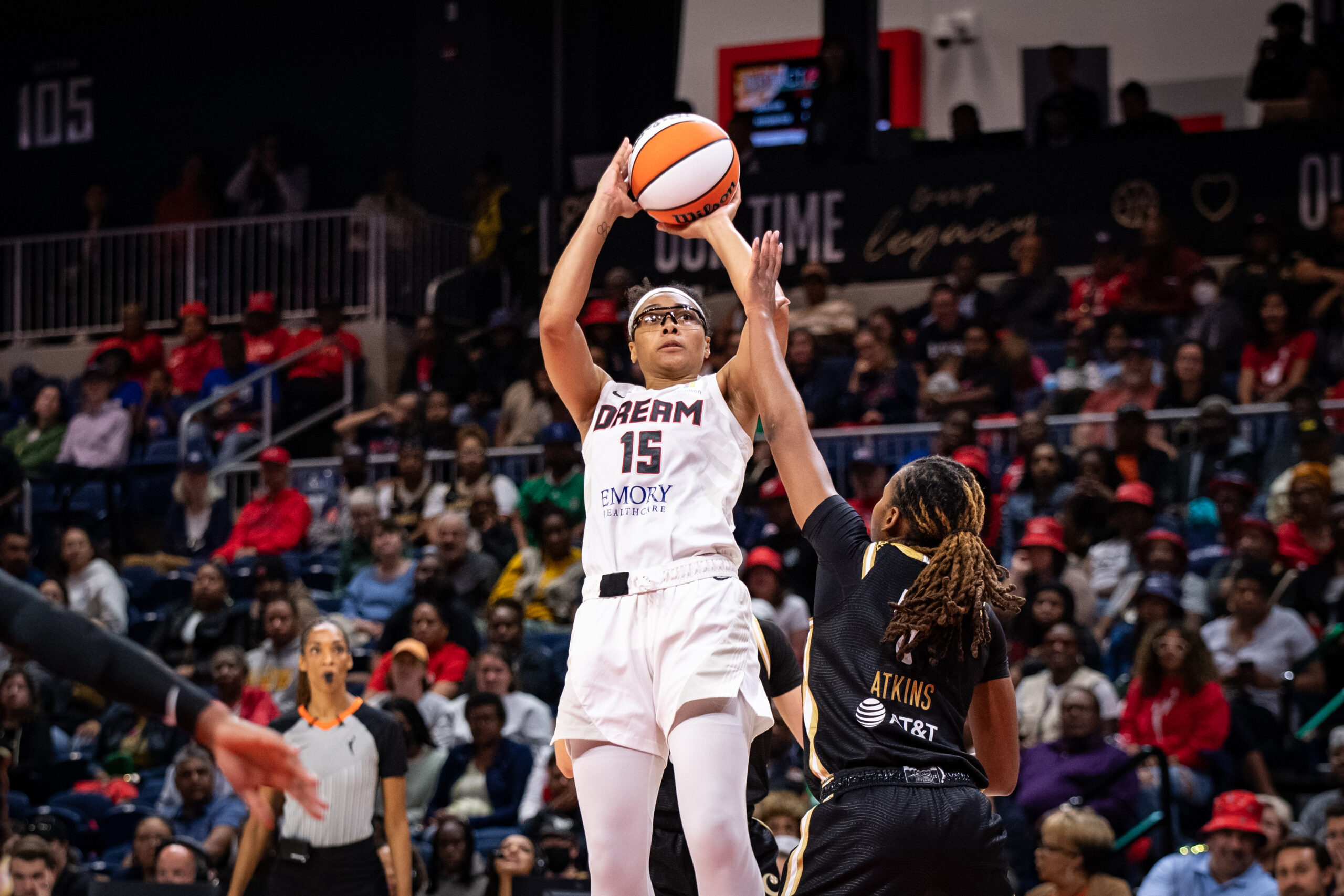 Atlanta Dream guard Allisha Gray attempts a jump shot over the outstretched hand of Washington Mystics guard Ariel Atkins.