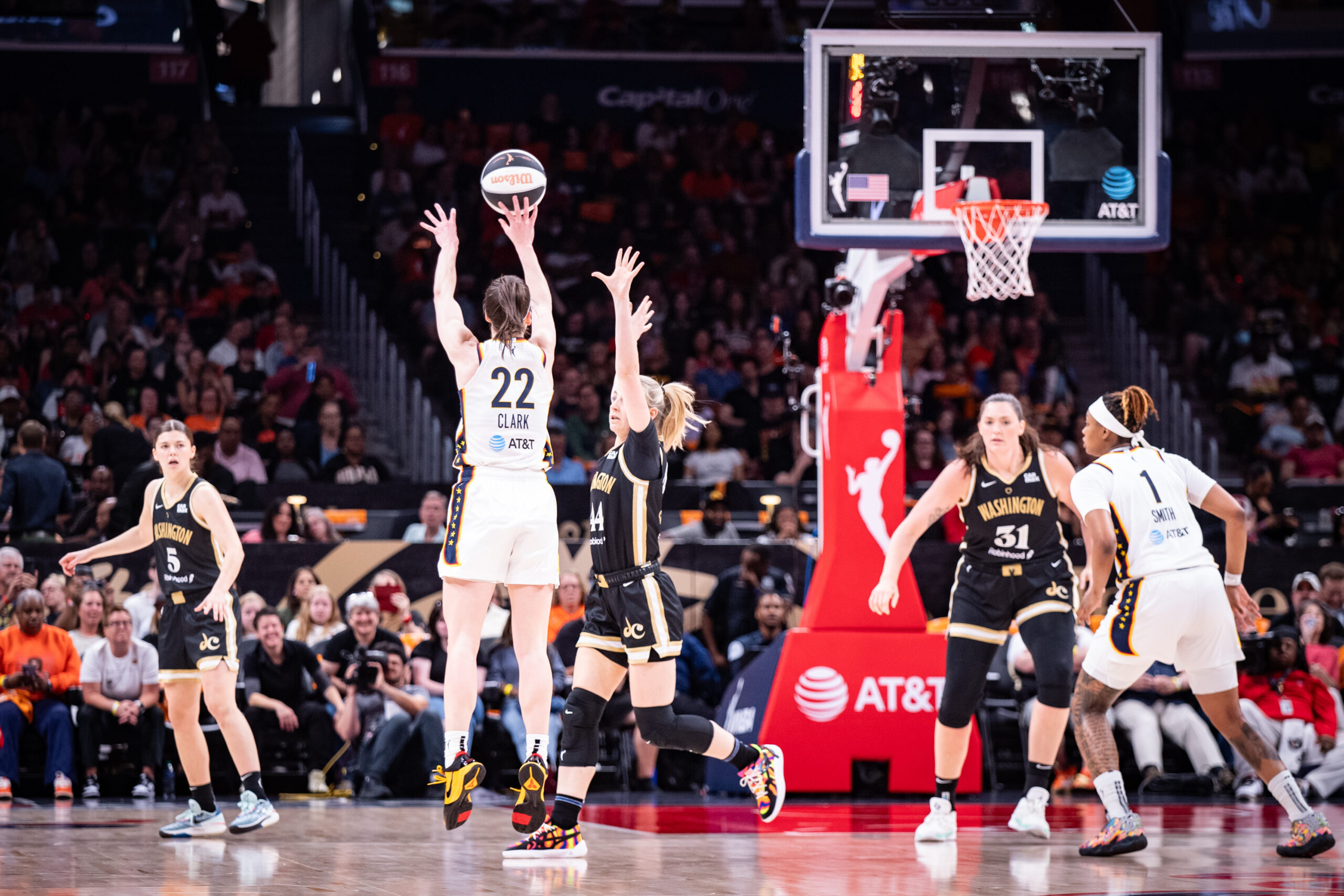 Indiana Fever guard Caitlin Clark shoots a right-handed jump shot as a Washington Mystics defender is late to close out.