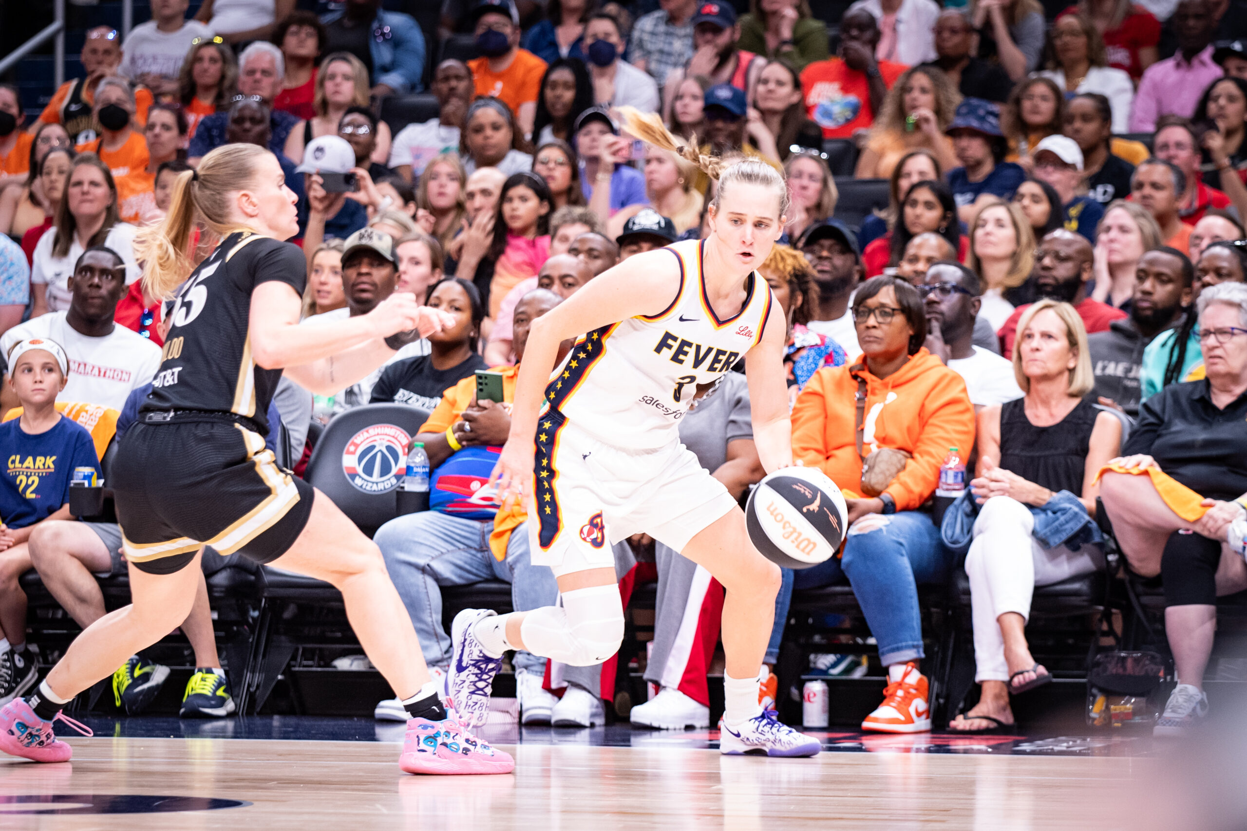 Indiana Fever guard Kristy Wallace dribbles the ball with her left hand.
