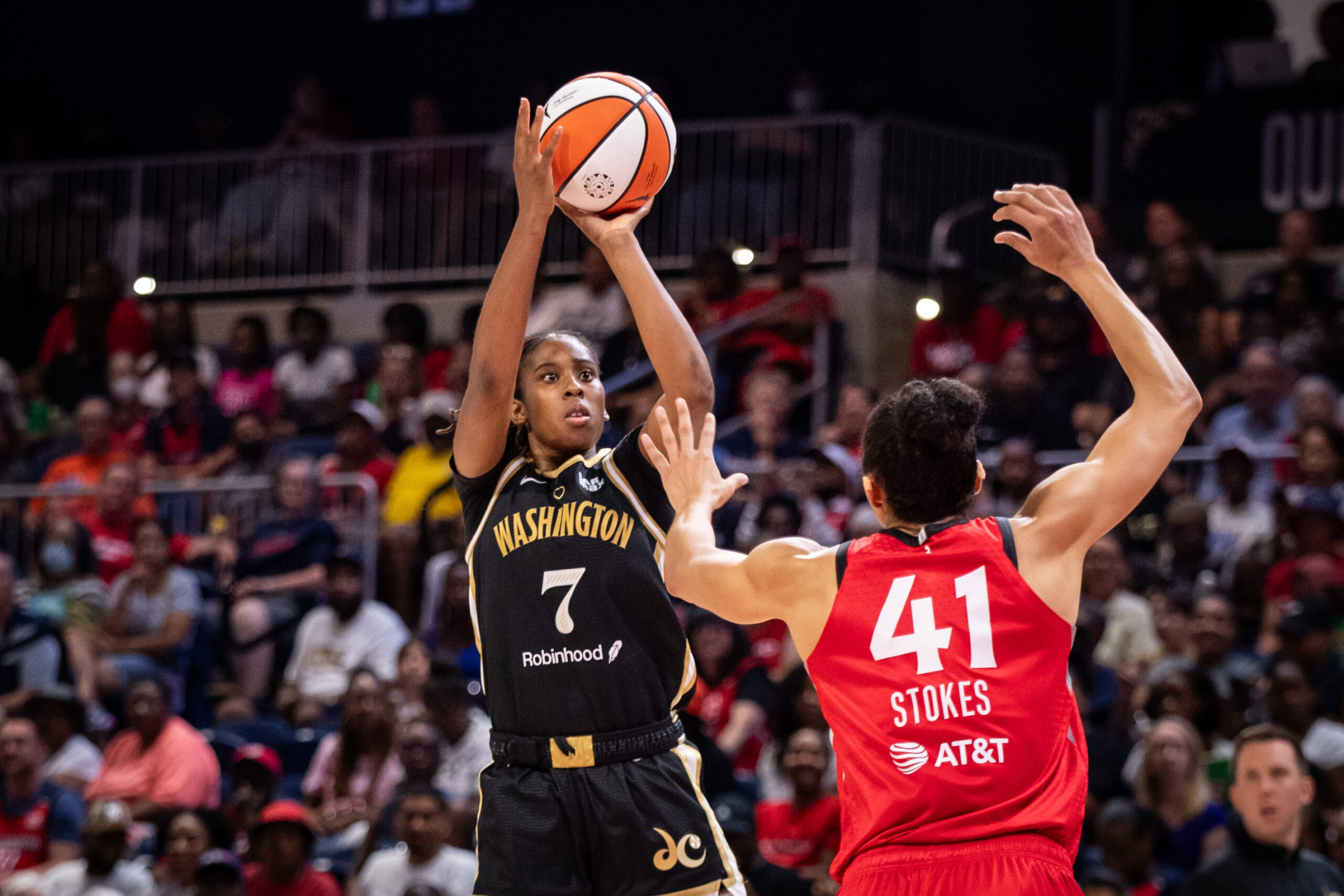Washington Mystics guard Ariel Atkins shoots a left-handed jump shot as Las Vegas Aces center Kiah Stokes arrives too late to get a hand up.