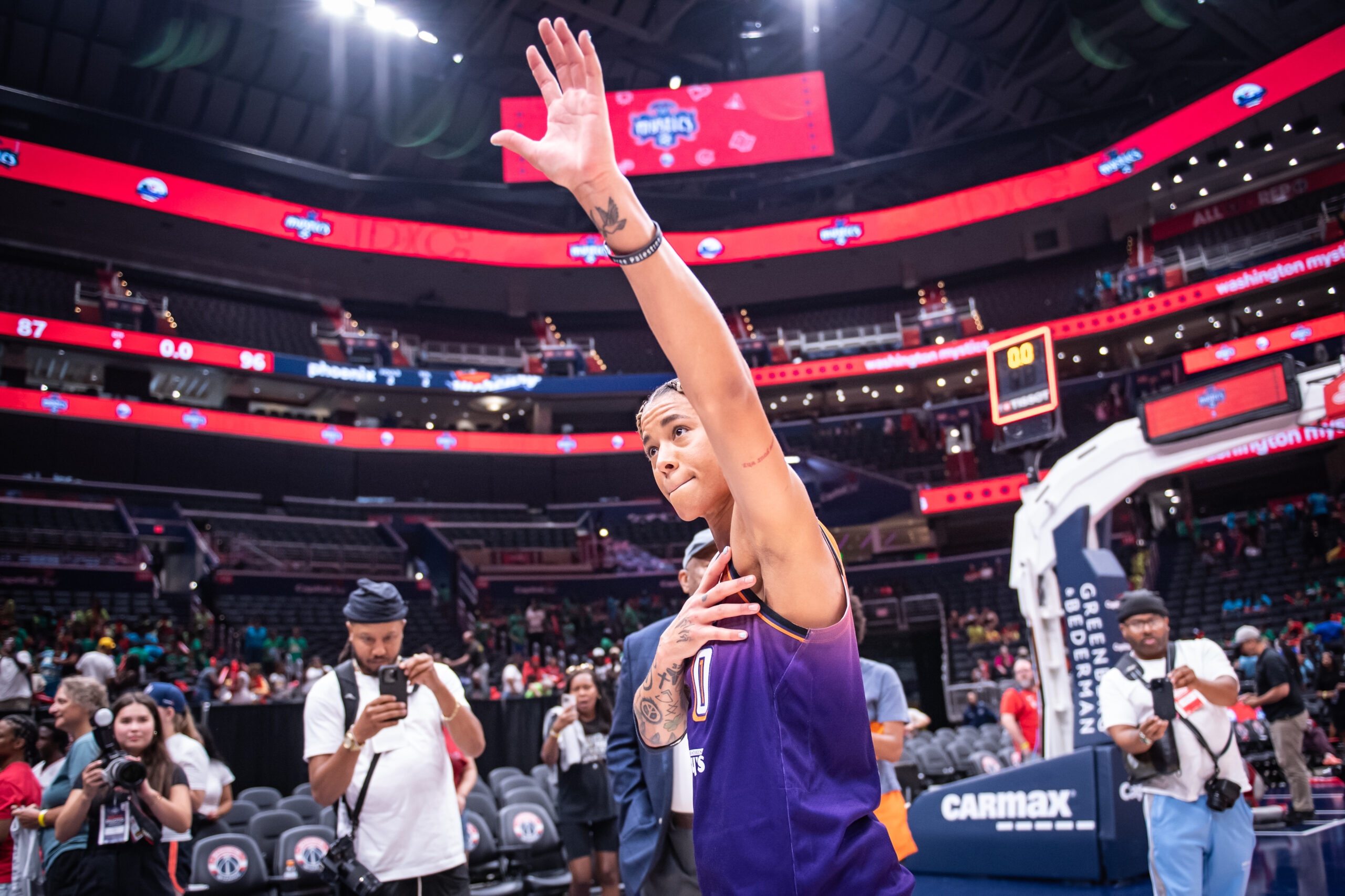 After her first game in Washington against her former team, Phoenix Mercury guard Natasha Cloud raises her left hand in the air and puts her right hand over her heart to acknowledge the crowd.