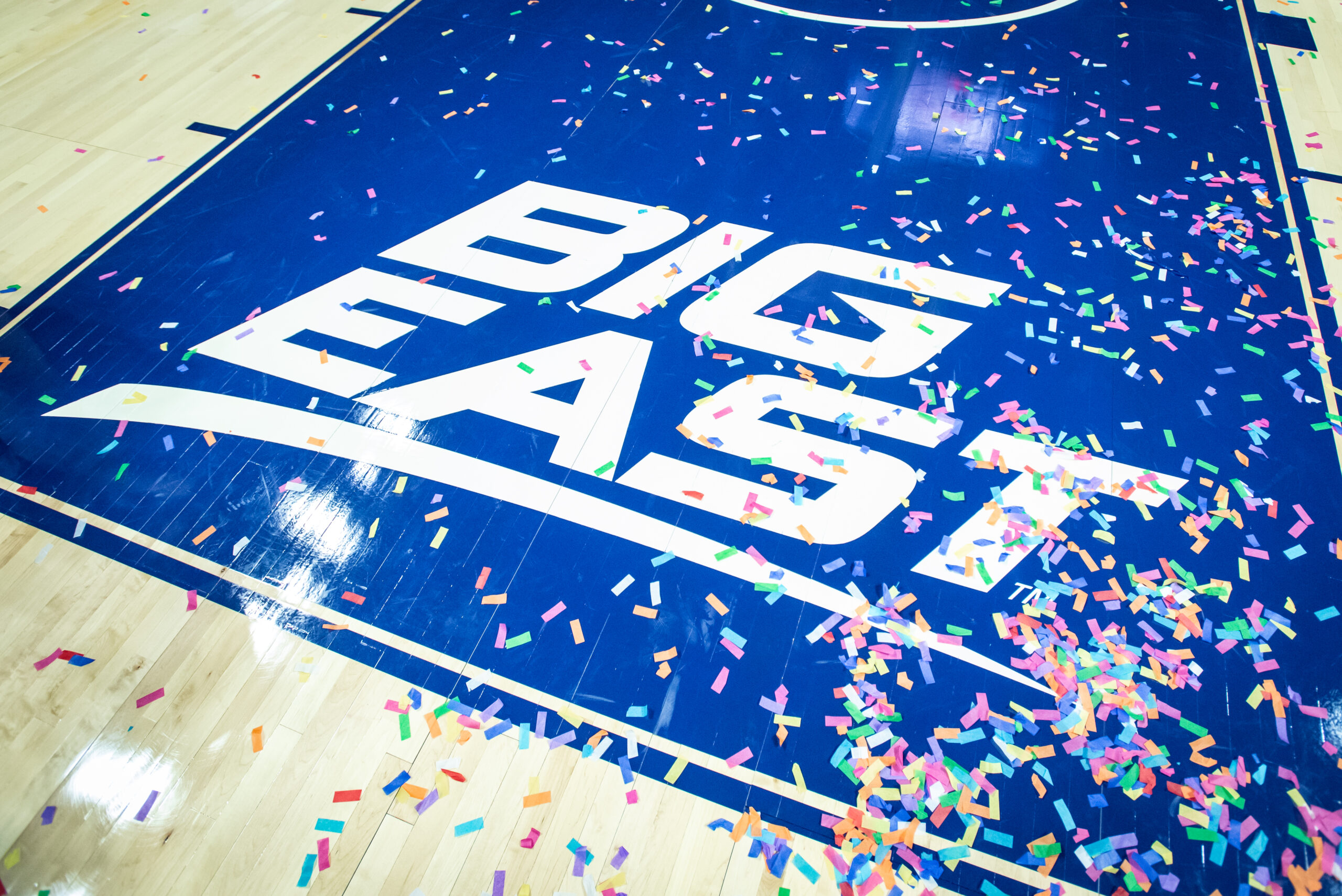 BIG EAST logo on a basketball court is covered with confetti