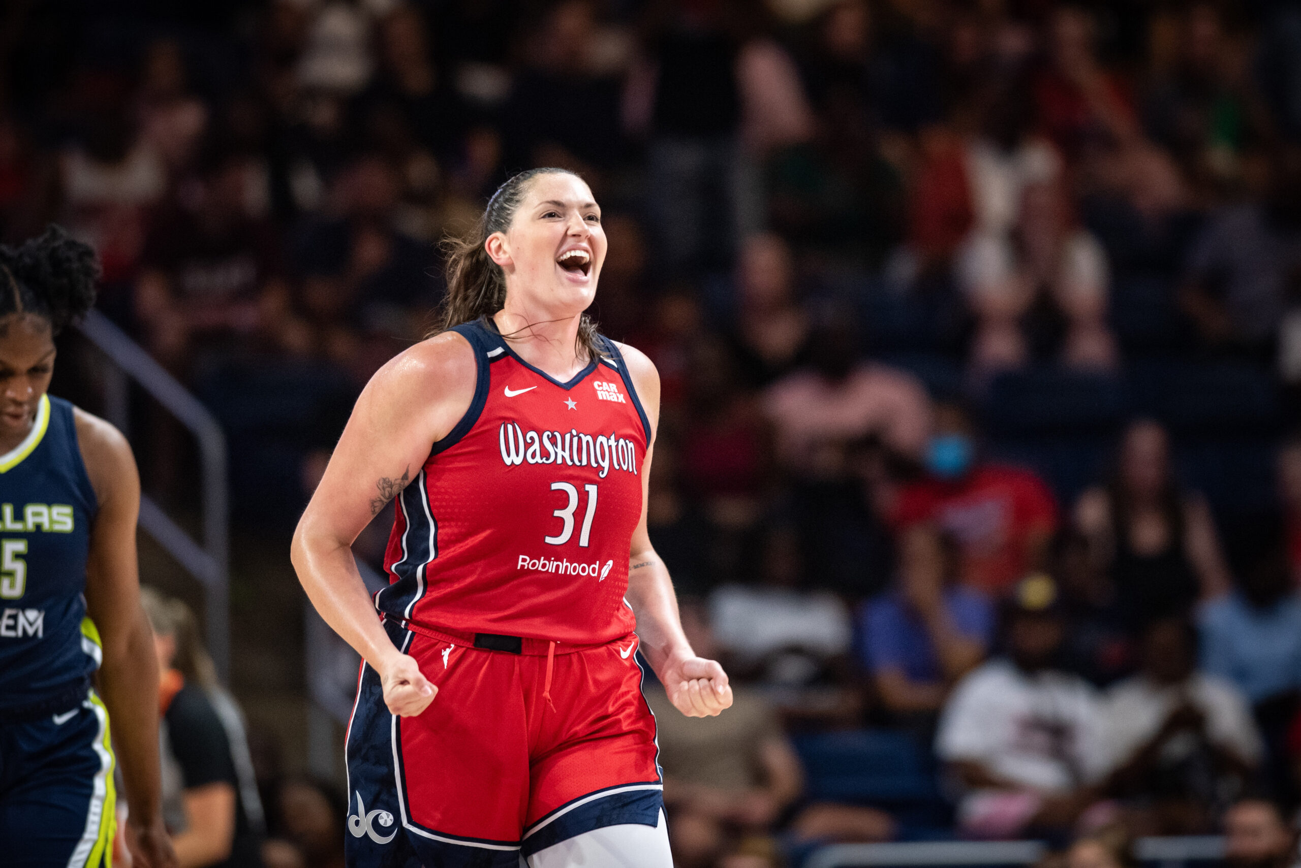 Washington Mystics center Stefanie Dolson smiles, shouts and clenches both fists in celebration.