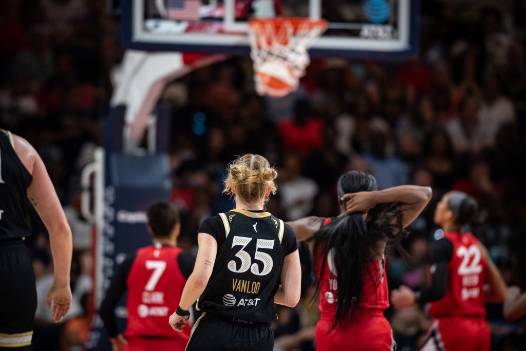 Washington Mystics point guard Julie Vanloo is shown from behind after taking a 3-pointer. She watches the basketball as it falls through the rim.